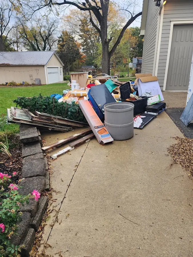 Dumpster being loaded with debris for Roofing Dumpster Rental in Butte-Silver Bow